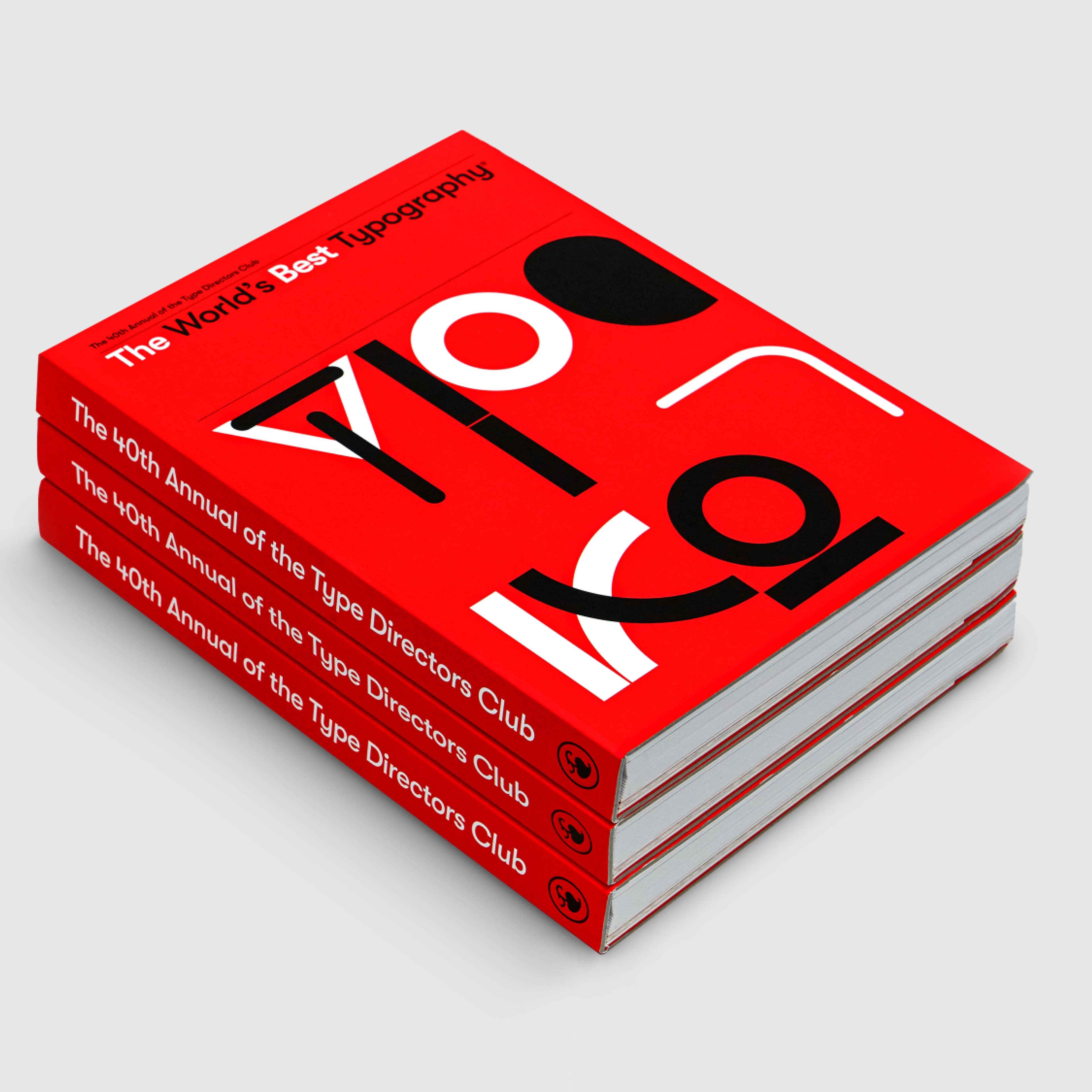 Stack of three red books titled 'The World's Best Typography', 40th Annual of the Type Directors Club, featuring bold typography.
