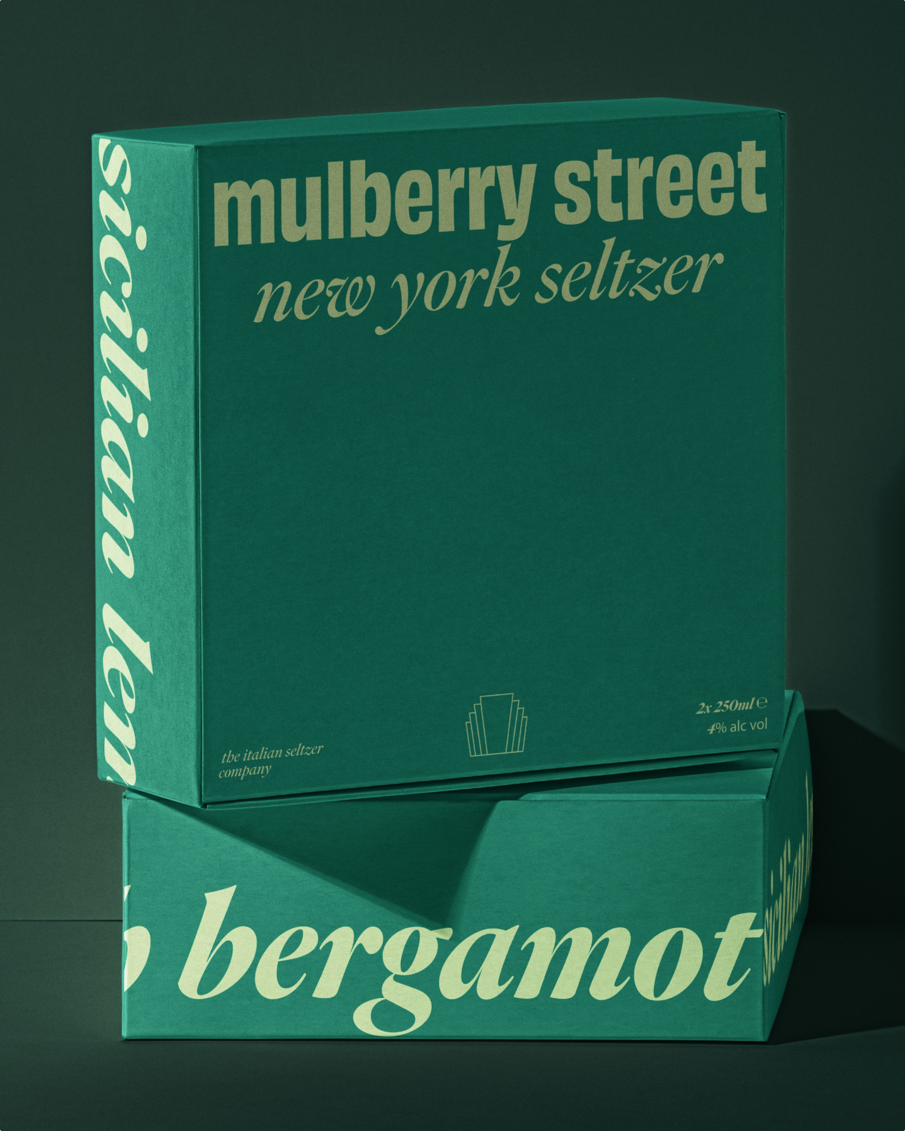 Two stacked green boxes of Mulberry Street New York Seltzer by The Italian Seltzer Company; upper box shows "Sicilian lemon" flavor, lower box shows "bergamot" flavor; each contains 2x 250ml at 4% alc vol.