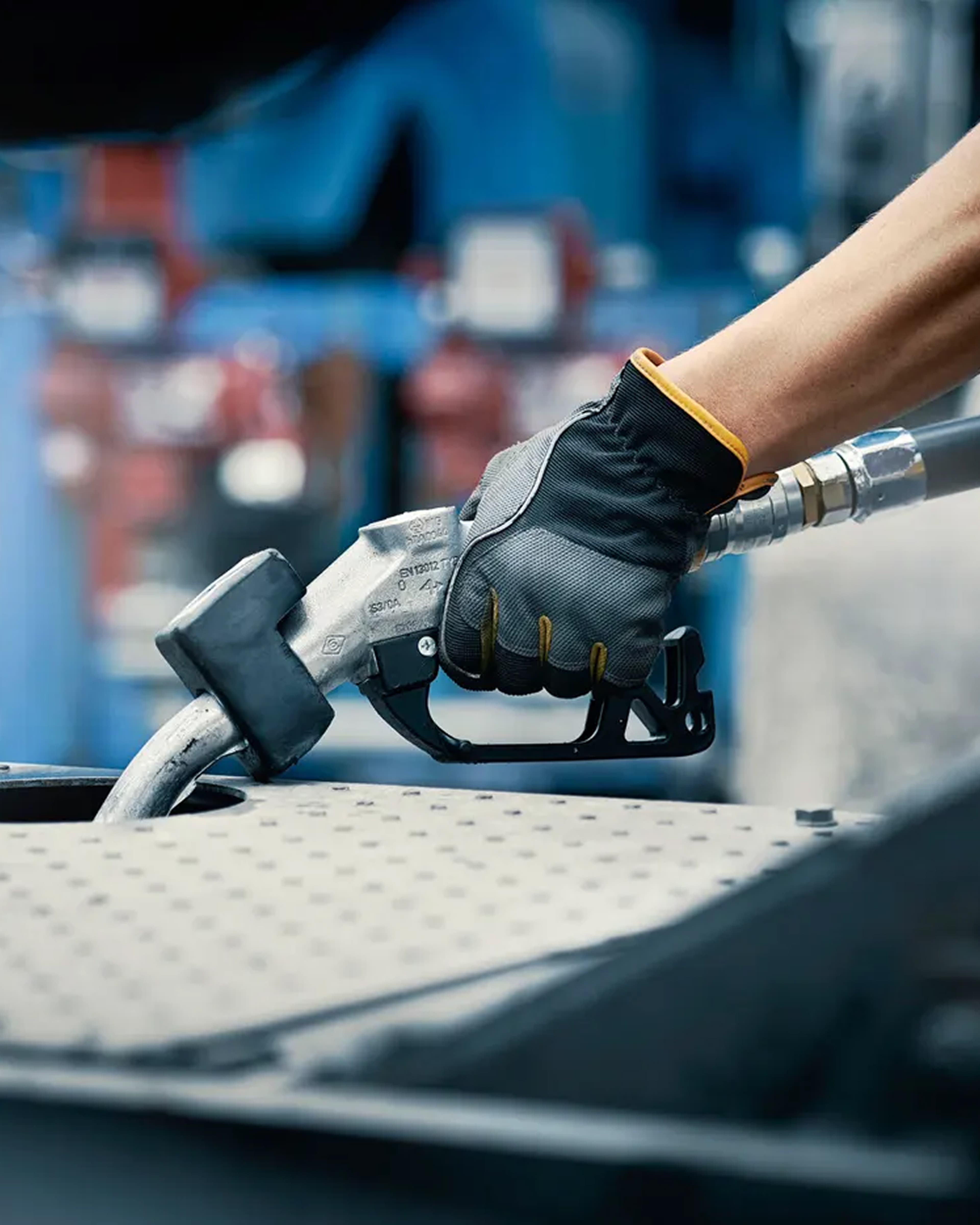 Picture of a hand reaching and grabbing a handle wearing a glove.