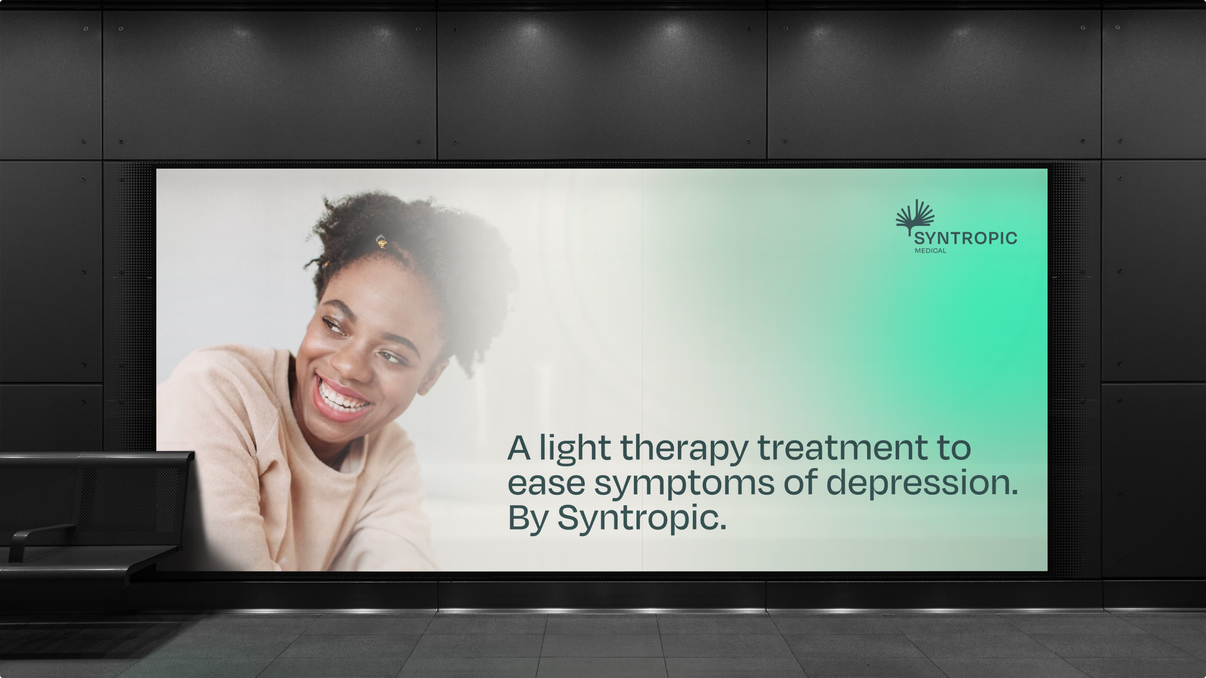 Billboard with an ad featuring a smiling woman and text promoting light therapy for depression by Syntropic Medical.