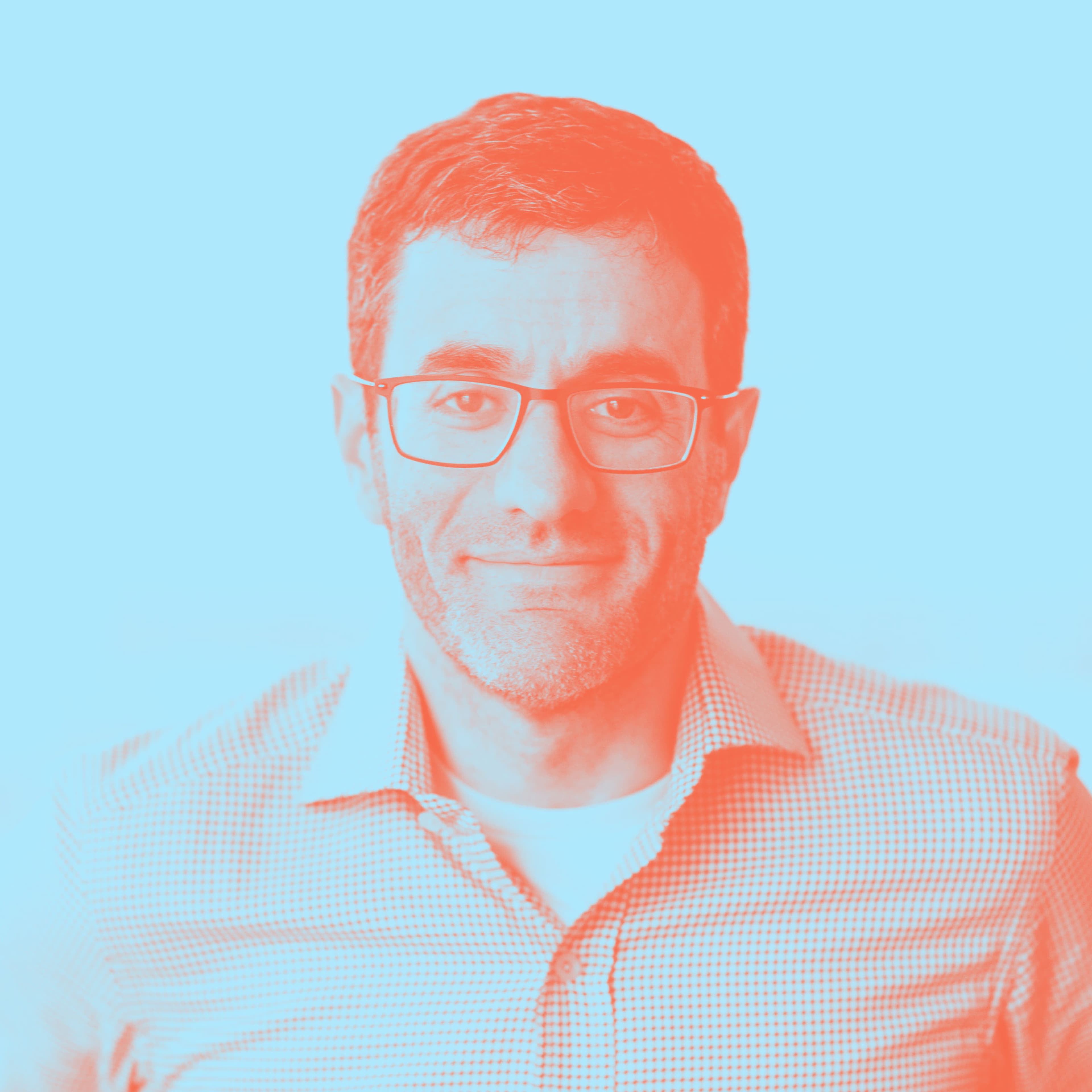 Artistic portrait of a man with glasses, wearing a checkered shirt against a dual-tone blue and red background.